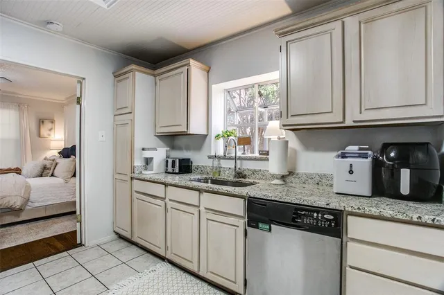 a kitchen with granite countertop a sink cabinets and window