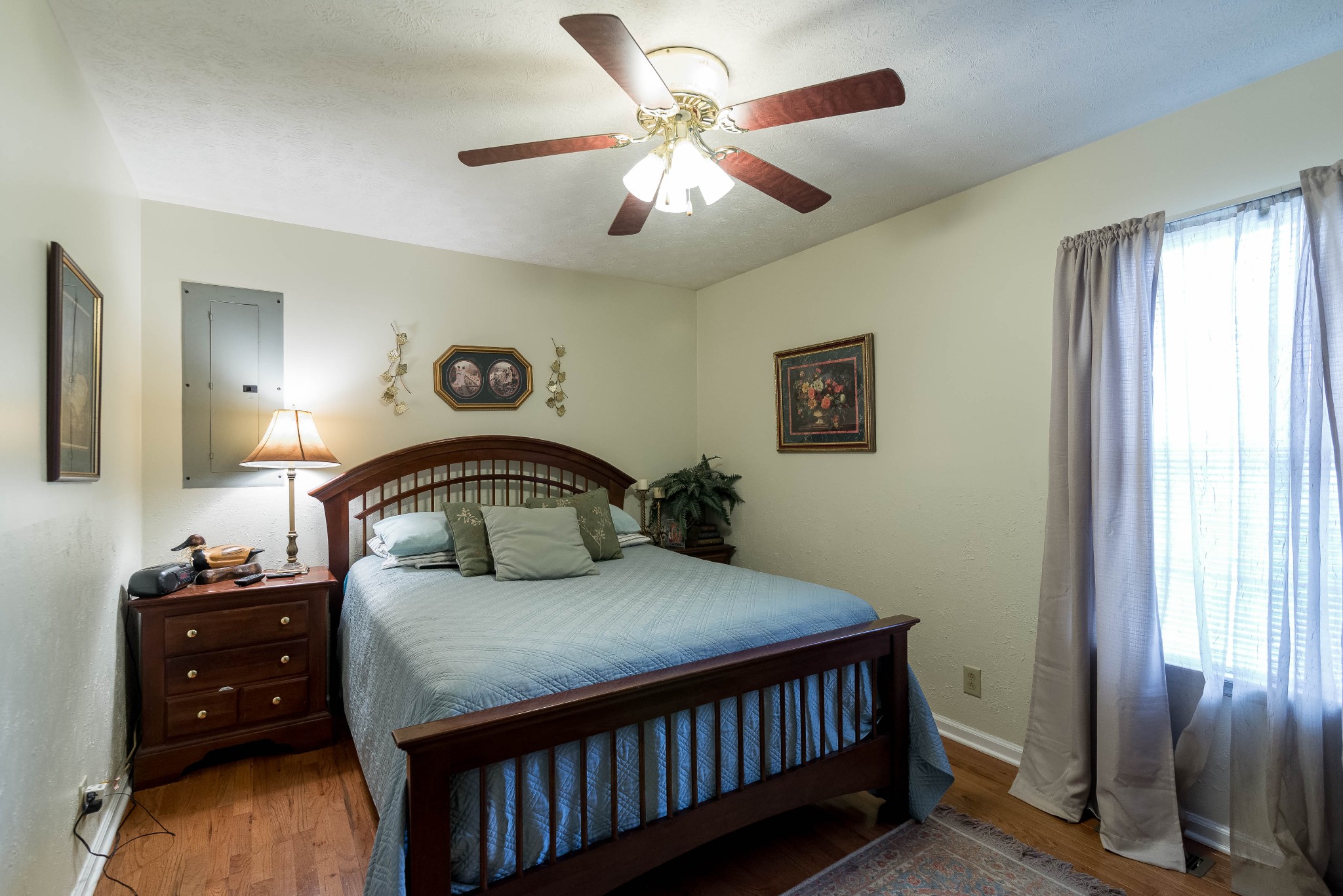 104 Brookside Point Springfield, TN 37172 - Photo 20 of 28 a bedroom with a bed and a chandelier