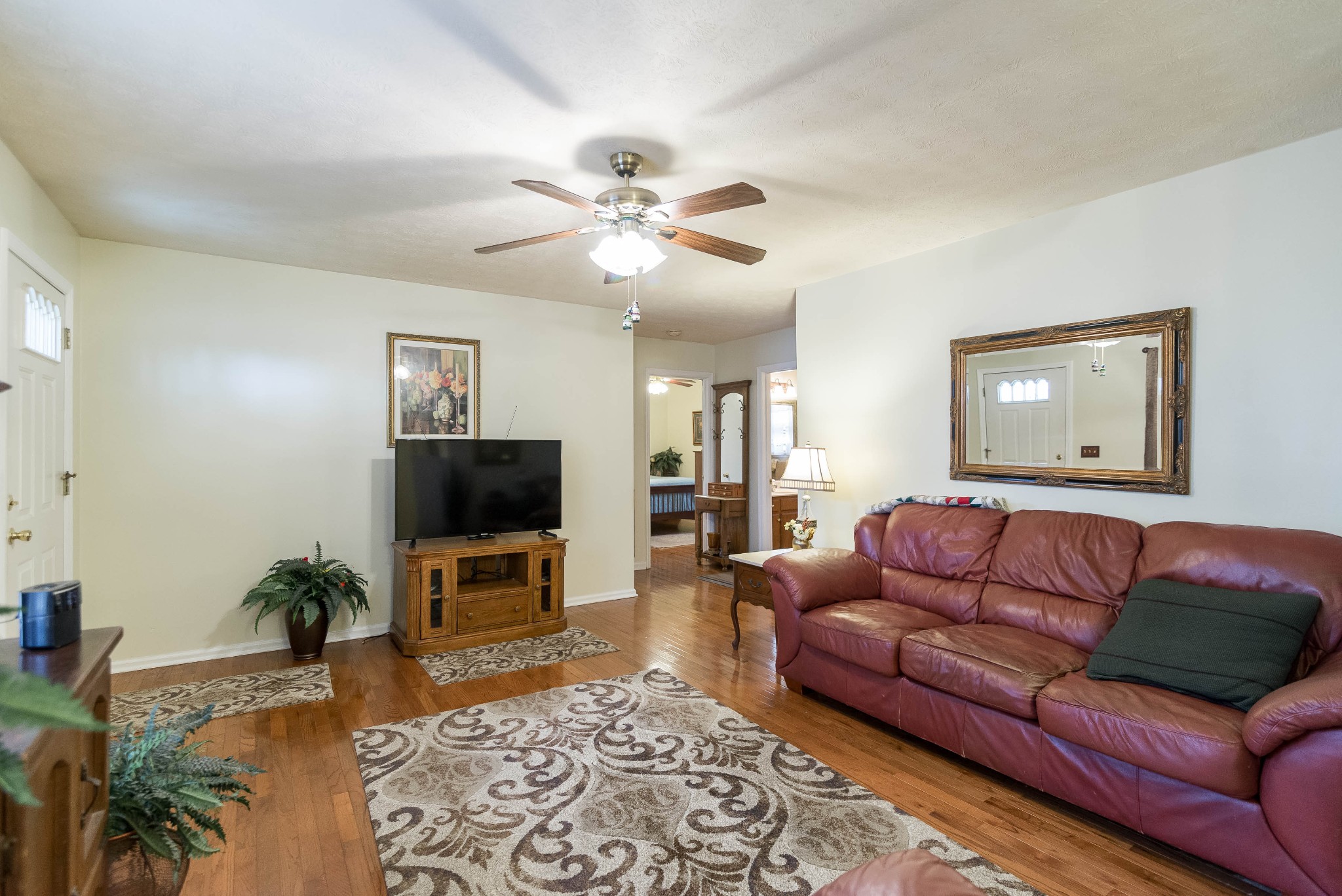 104 Brookside Point Springfield, TN 37172 - Photo 8 of 28 a living room with furniture a flat screen tv and a fireplace