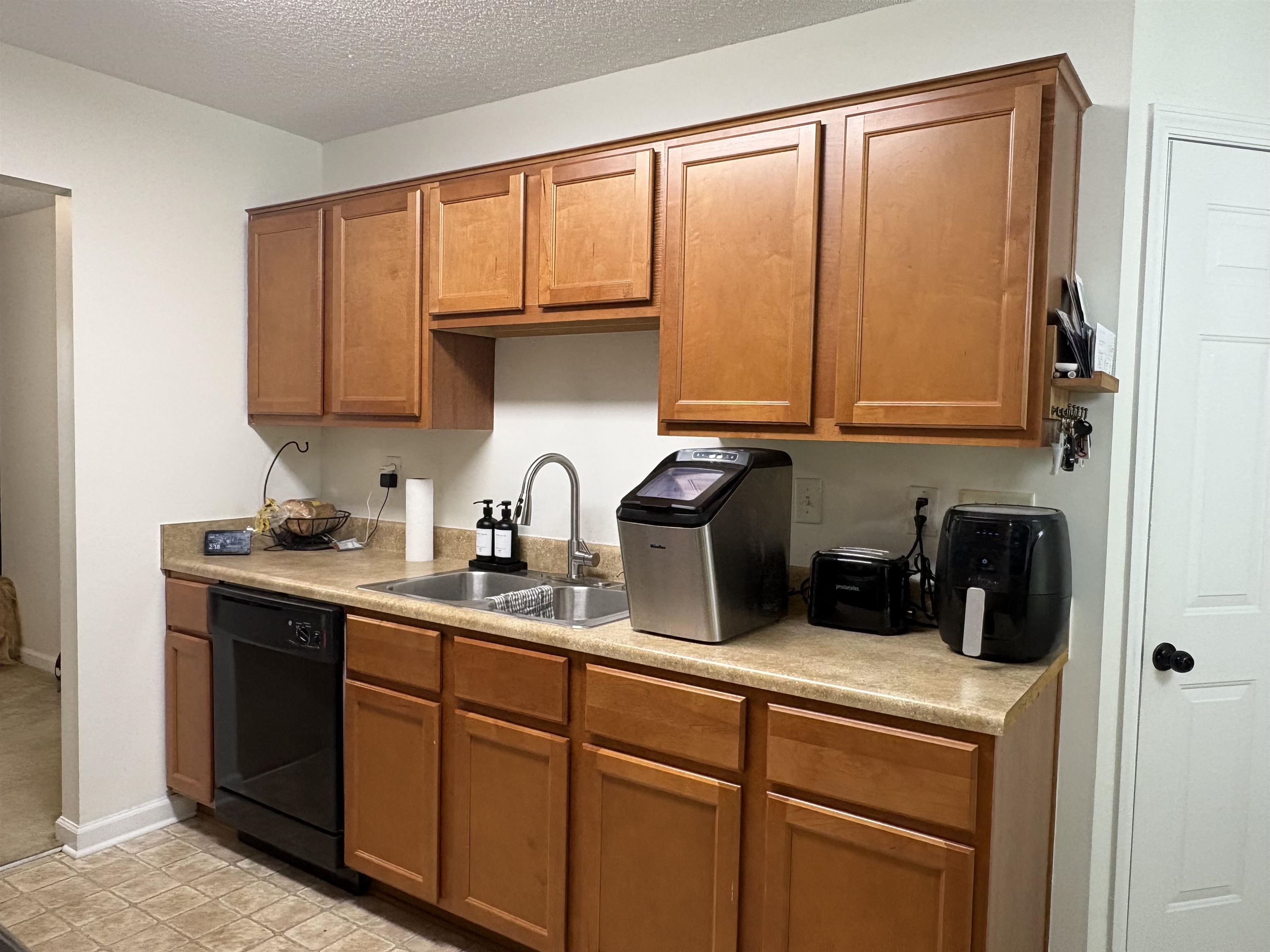 4356 Cedar Hills Road Memphis, TN 38135 - Photo 8 of 29 Kitchen with wood-finish cabinetry and light-toned countertops