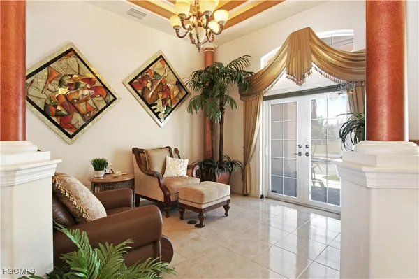 a living room with furniture and a chandelier