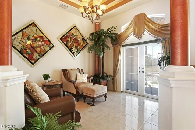 a living room with furniture and a chandelier