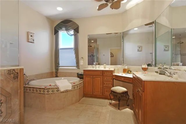 a bathroom with a tub sink and mirror