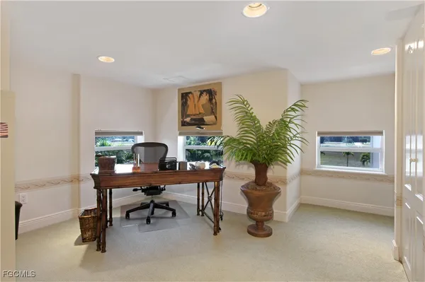 a work room with furniture and a potted plant