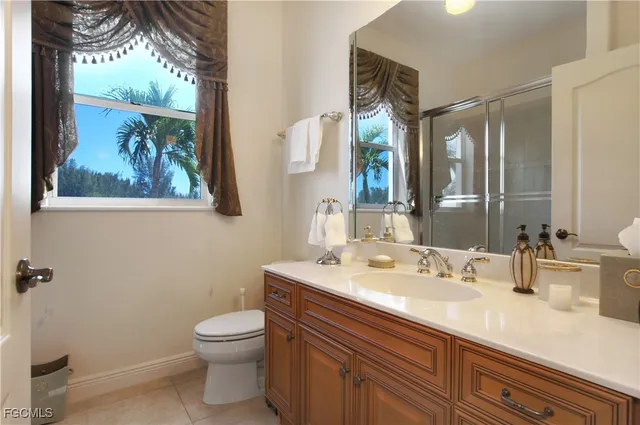 a bathroom with a toilet a sink and mirror