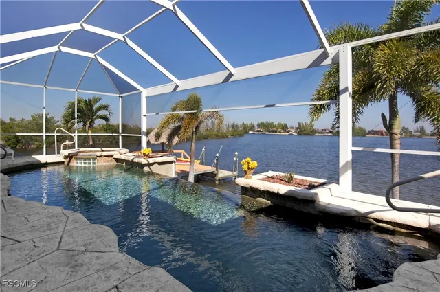 a view of a patio with table and chairs under an umbrella