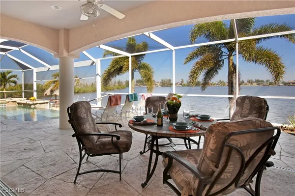 a dining room with furniture and a floor to ceiling window