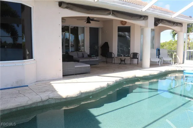 a view of swimming pool with outdoor seating