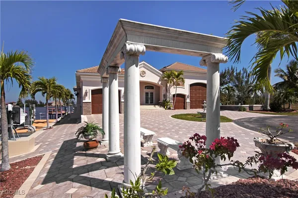 a view of a lake with lawn chairs and a table