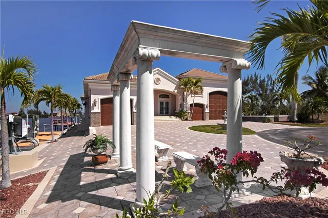 a view of a lake with lawn chairs and a table