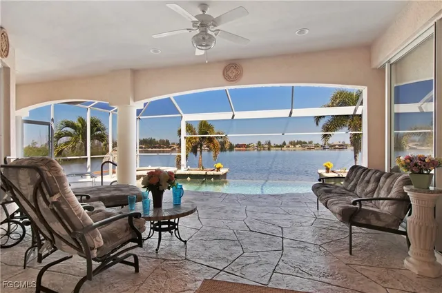 a living room with patio furniture and a floor to ceiling window