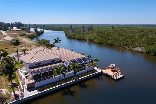 an aerial view of a house with outdoor space and lake view