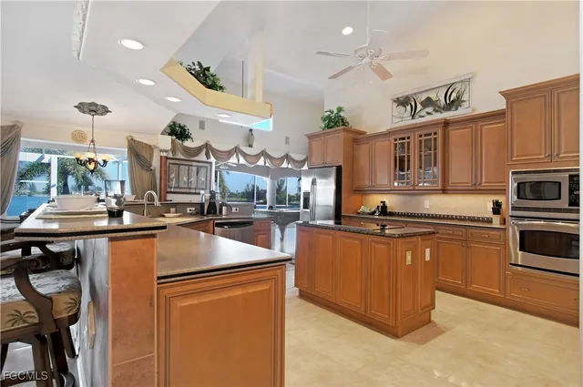 a kitchen with stainless steel appliances granite countertop a sink a stove and a refrigerator