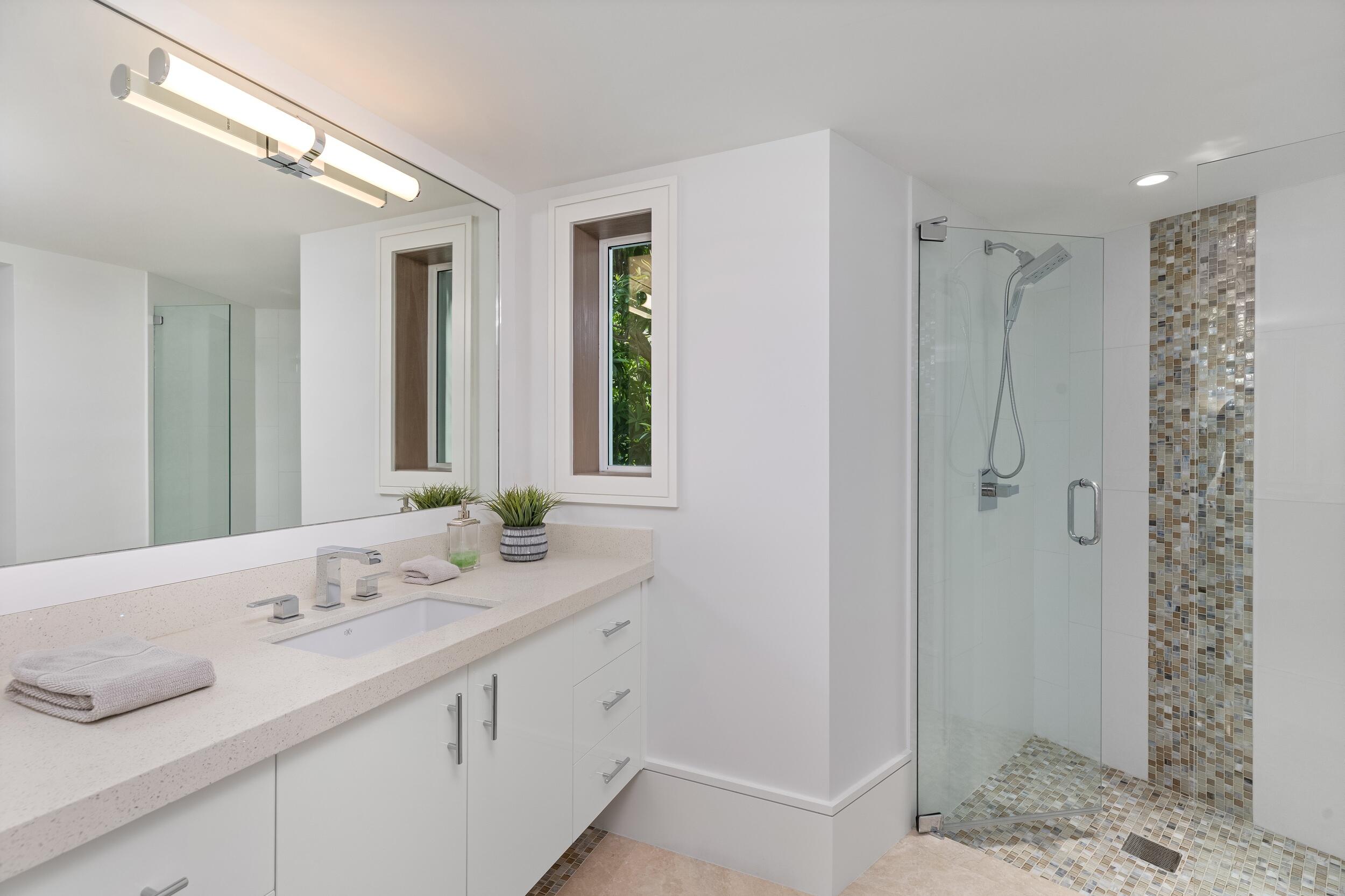 863 Enfield Street Boca Raton, FL 33487 - Photo 17 of 67 a bathroom with a shower sink and mirror