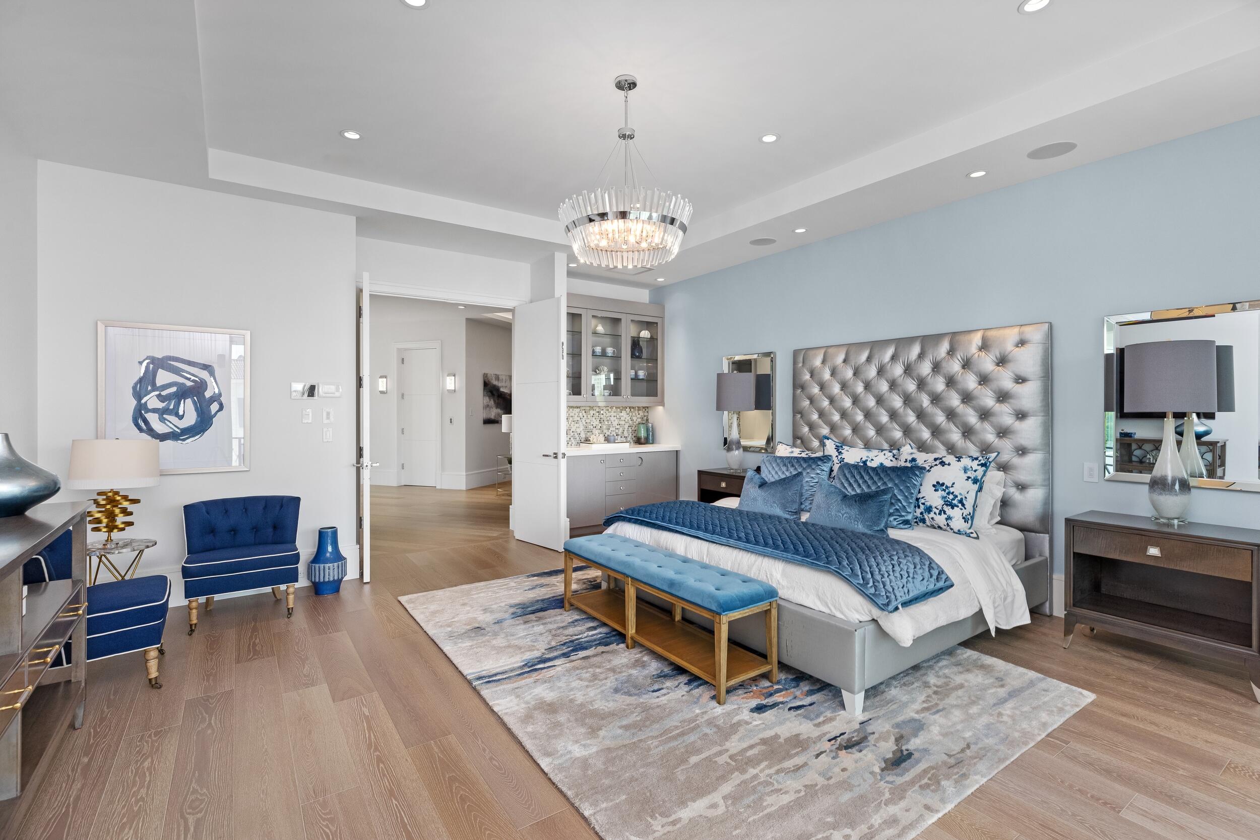 863 Enfield Street Boca Raton, FL 33487 - Photo 40 of 67 a bedroom with a bed and a chandelier