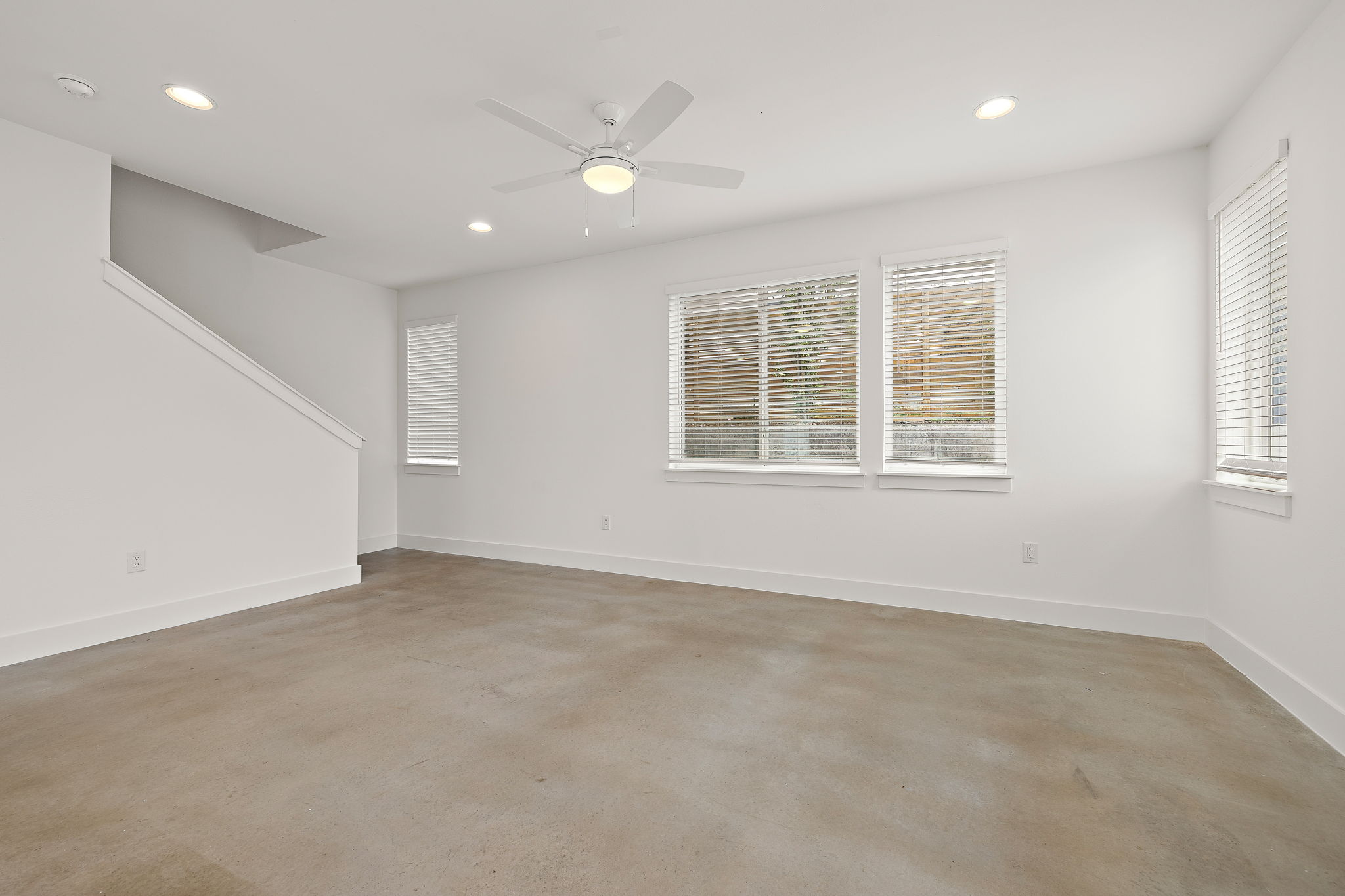 1206 Sarabeth Way Austin, TX 78721 - Photo 8 of 27 Spare room featuring plenty of natural light, concrete flooring, and recessed lighting