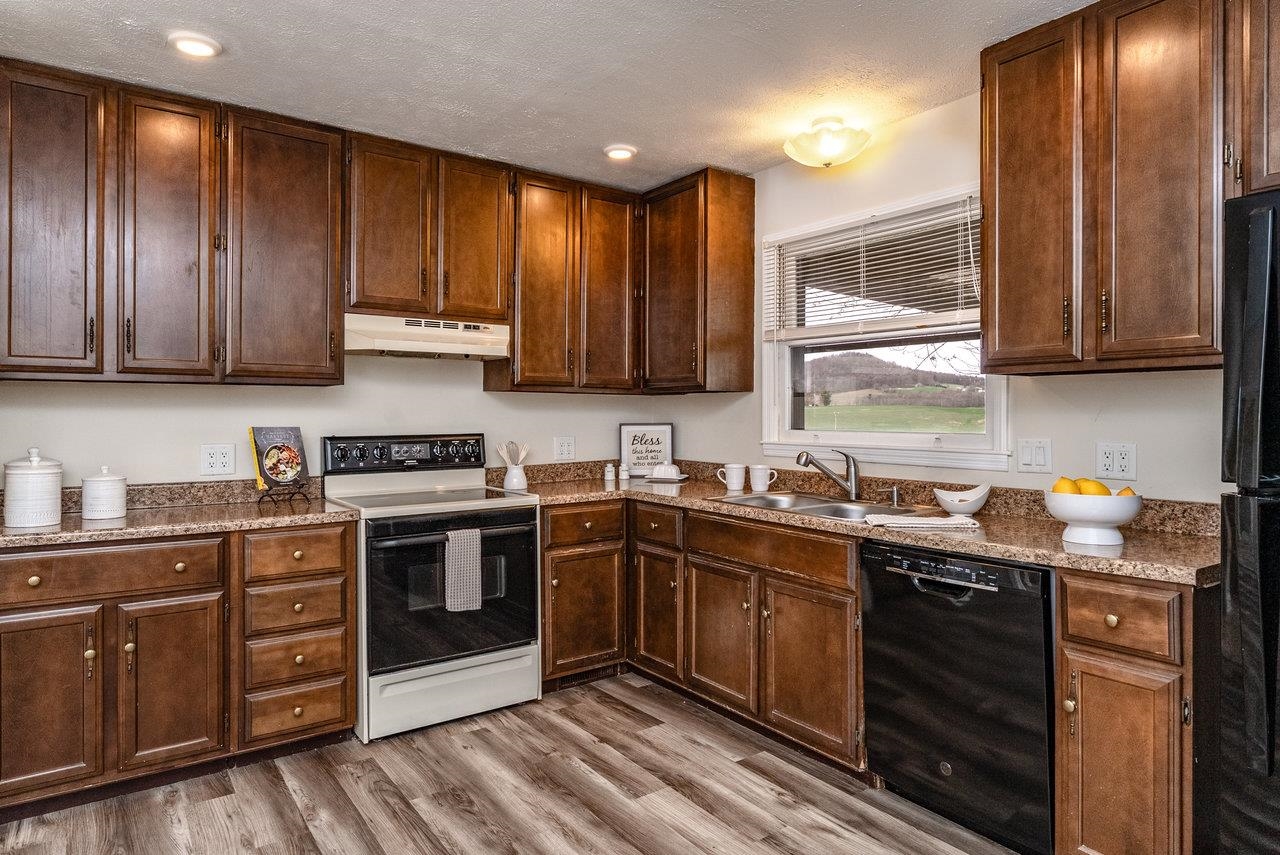 456 Eckert Circle Harrisonburg, VA 22801 - Photo 12 of 48 a kitchen with stainless steel appliances granite countertop wooden cabinets stove top oven and sink