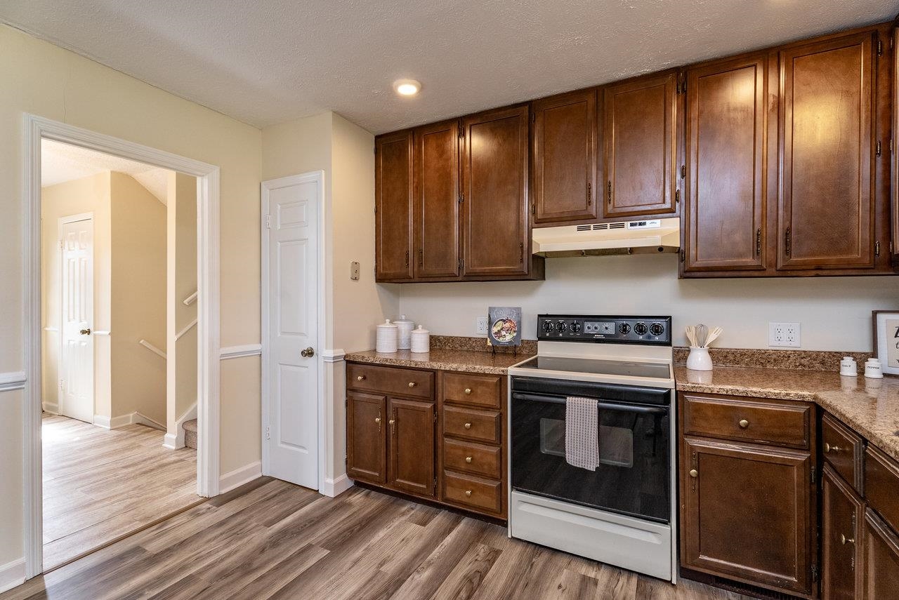 456 Eckert Circle Harrisonburg, VA 22801 - Photo 14 of 48 a kitchen with stainless steel appliances granite countertop wooden cabinets and a stove top oven