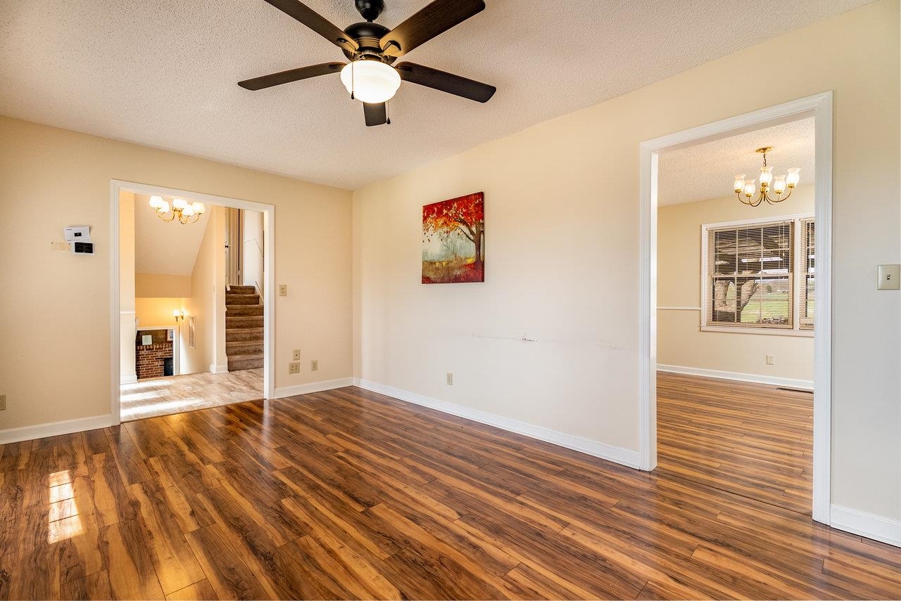 456 Eckert Circle Harrisonburg, VA 22801 - Photo 6 of 48 an empty room with wooden floor chandelier fan and windows