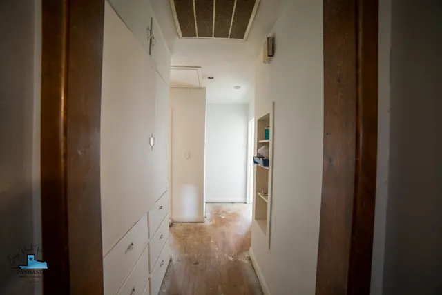 a view of hallway with wooden floor