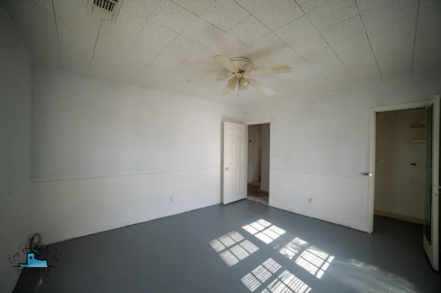 a view of an empty room with a window