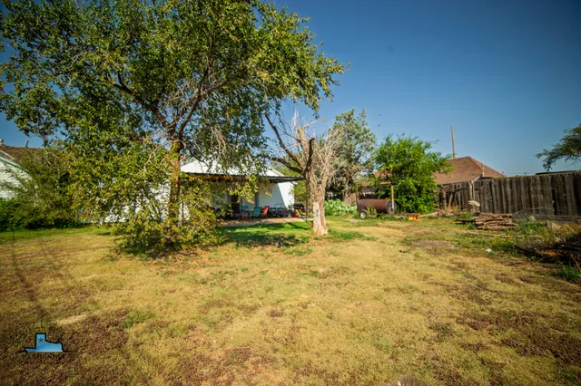 a view of backyard with swimming pool
