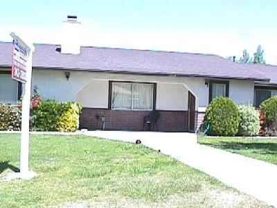 13845 Hidden Valley Road Victorville, CA 92395 - Photo 1 of 1 a front view of a house with a yard and garage