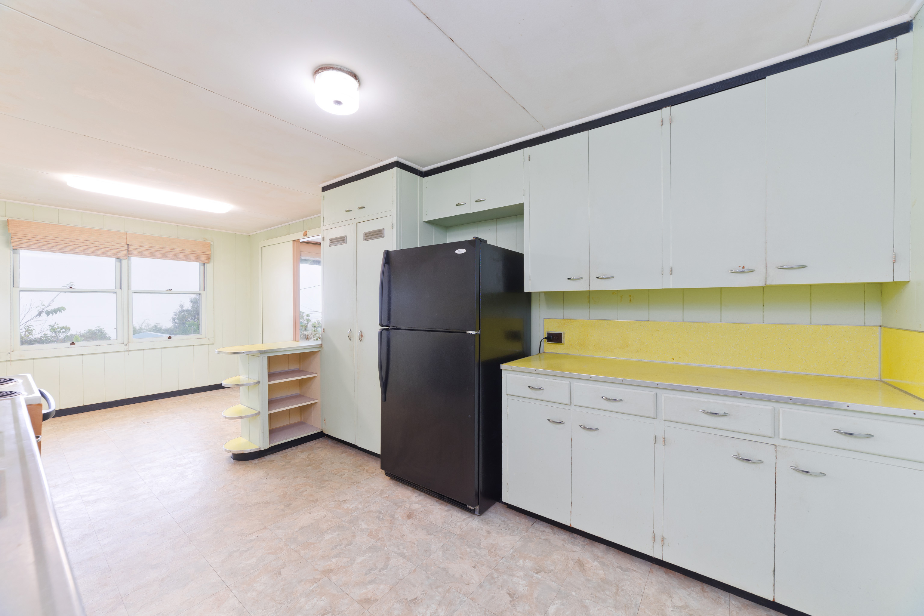 81-1028 Captain Cook Road Captain Cook, HI 96704 - Photo 8 of 22 a kitchen with a refrigerator and cabinets
