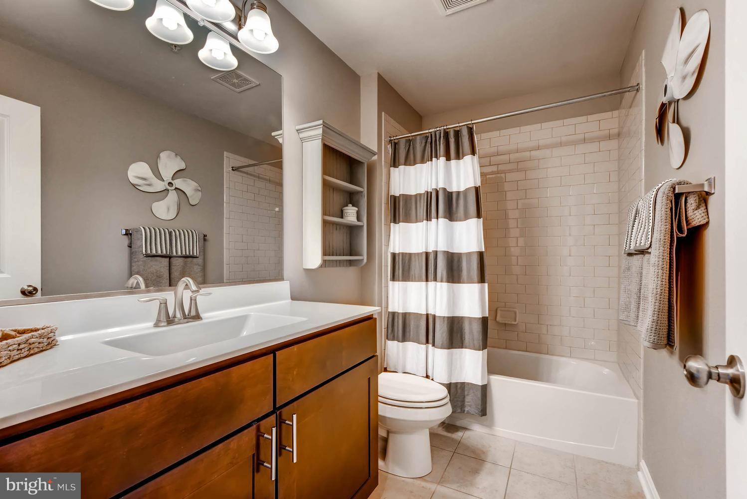 2033 Case Road Baltimore, MD 21222 - Photo 15 of 30 a bathroom with a sink a toilet and shower