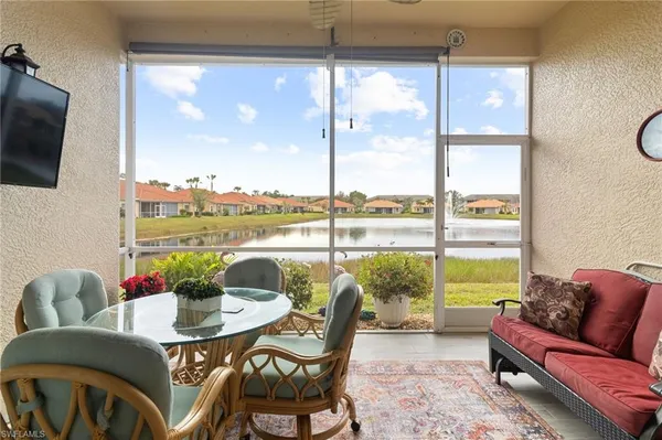 a living room with furniture and a floor to ceiling window