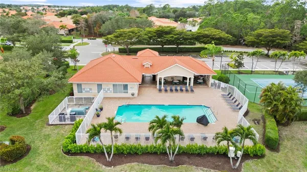 an aerial view of house with yard swimming pool and outdoor seating