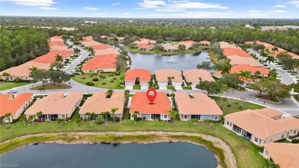 an aerial view of a house with a garden and lake view