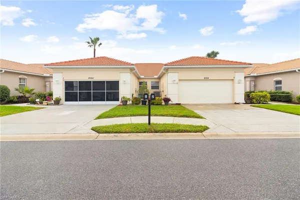 a house view with a garden and garage