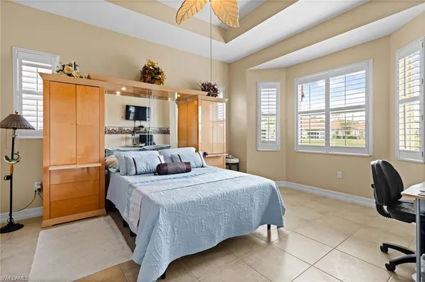 a bedroom with a bed a couch and dresser