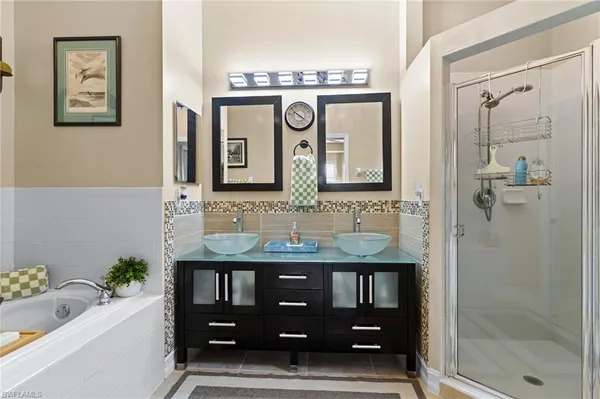 a bathroom with a sink a vanity and a shower