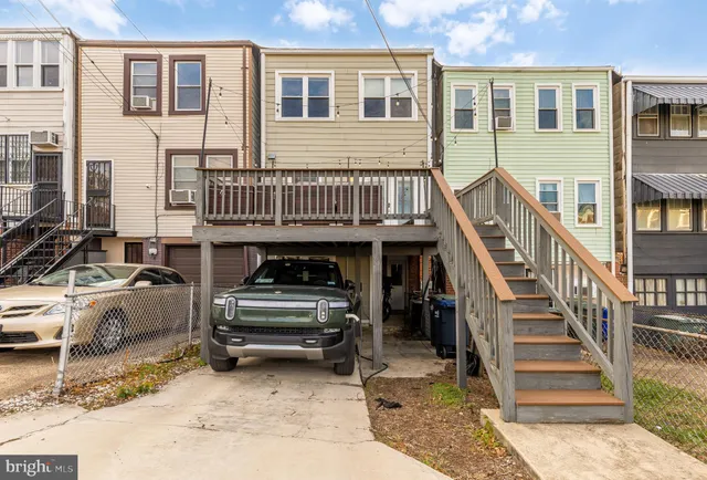 a bed sitting in a spacious bedroom next to a window