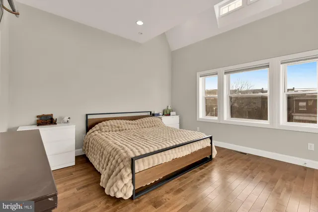 a bedroom with a bed and a large window