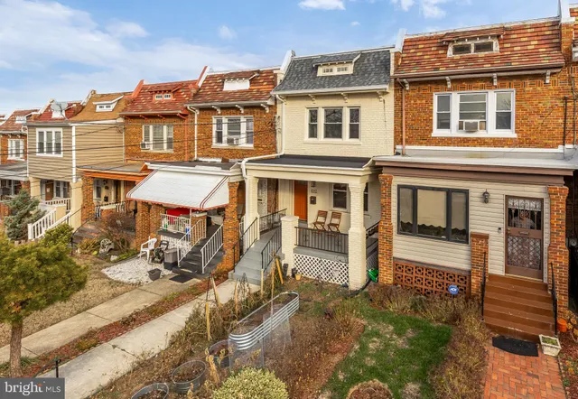 a front view of a residential apartment building with a yard