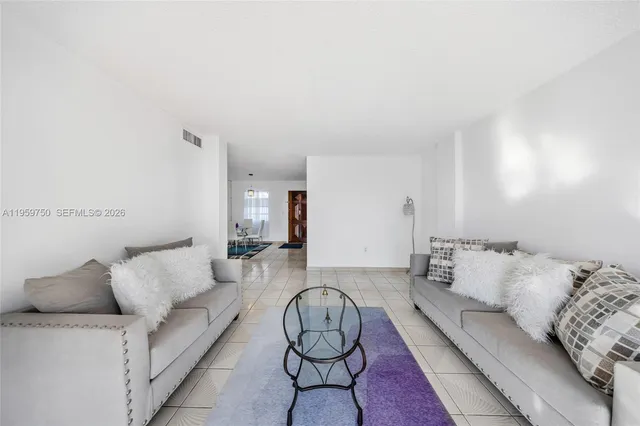 a living room with furniture a rug and couch