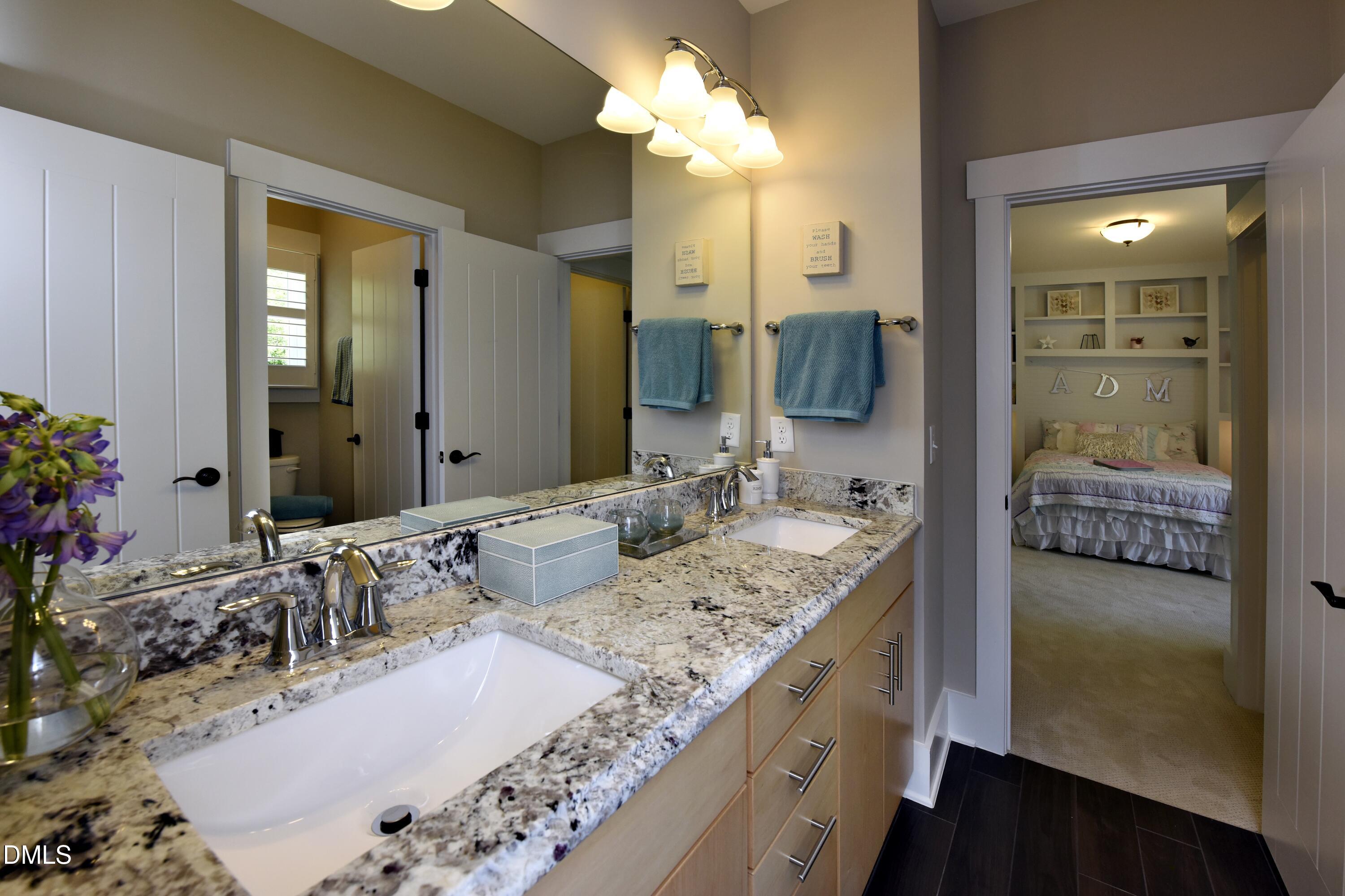4 Wolf Tree Way Efland, NC 27243 - Photo 20 of 28 a bathroom with a granite countertop sink and a mirror