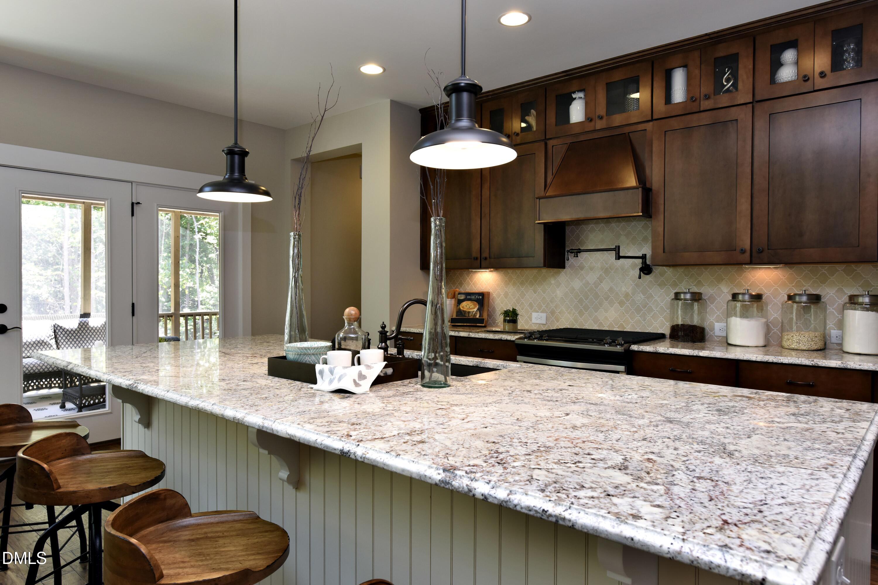 4 Wolf Tree Way Efland, NC 27243 - Photo 5 of 28 a kitchen with stainless steel appliances granite countertop a sink a stove and a wooden cabinets