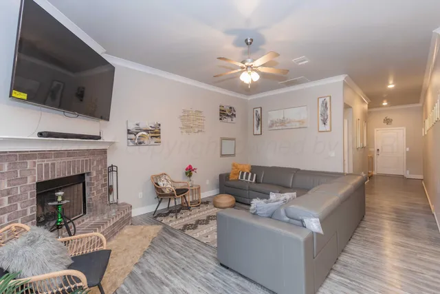 a living room with furniture and a fireplace