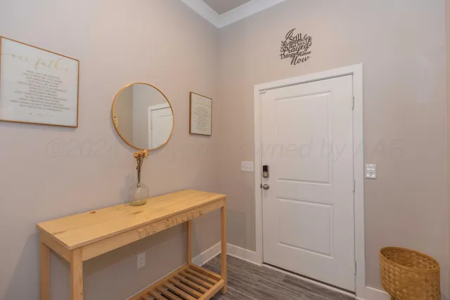 a room with a table and a chandelier