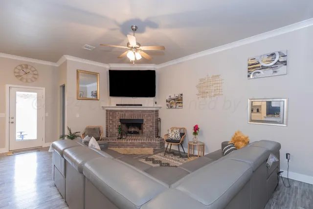 a living room with fireplace furniture and a flat screen tv