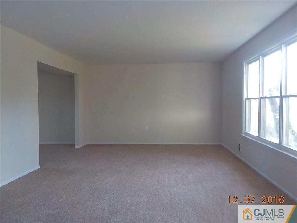 8 Higgins Road Old Bridge, NJ 08857 - Photo 4 of 15 an empty room with a window
