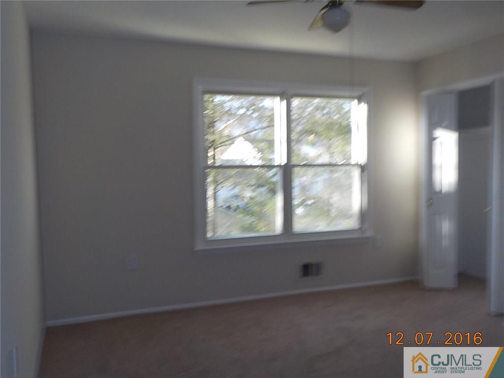 8 Higgins Road Old Bridge, NJ 08857 - Photo 5 of 15 an empty room with a window
