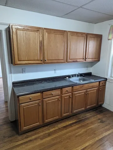 a kitchen with granite countertop cabinets and black appliances