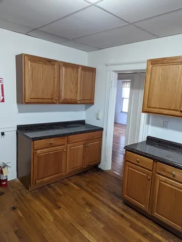 a kitchen with granite countertop wooden cabinets and a sink