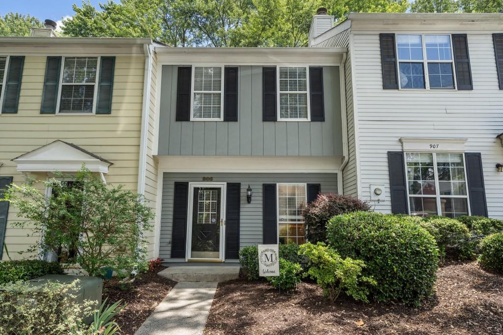 906 Wedgewood Way Sandy Springs, GA 30350 - Photo 1 of 1 a view of a brick house with large windows and plants