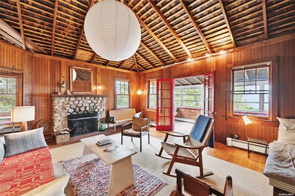 a living room with fireplace furniture and a large window
